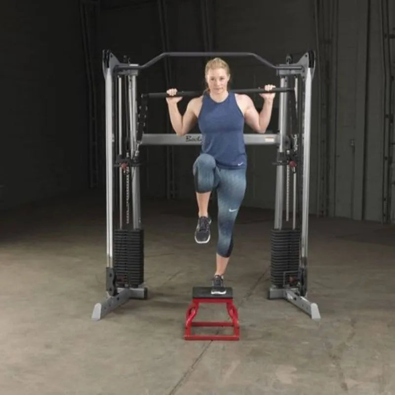 Body-Solid Bar Attachment GDCCBAR - Female model standing on a small red chair with one foot while holding bar attachment