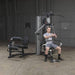 Body-Solid Bi-Angular Multi-Stack Gym G10B - Man sitting on multi stack gym