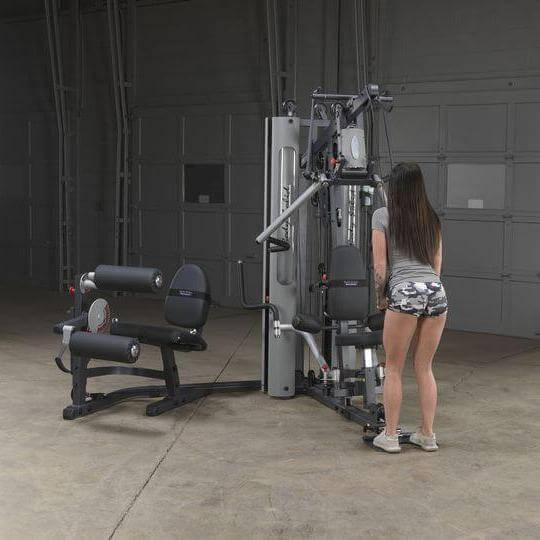 Body-Solid Bi-Angular Multi-Stack Gym G10B - Female model standing in front of multi stack gym