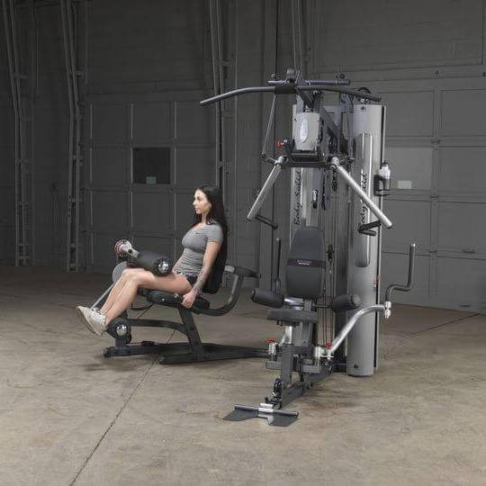 Body-Solid Bi-Angular Multi-Stack Gym G10B - Woman in gray shirt sitting on multi stack gym bench