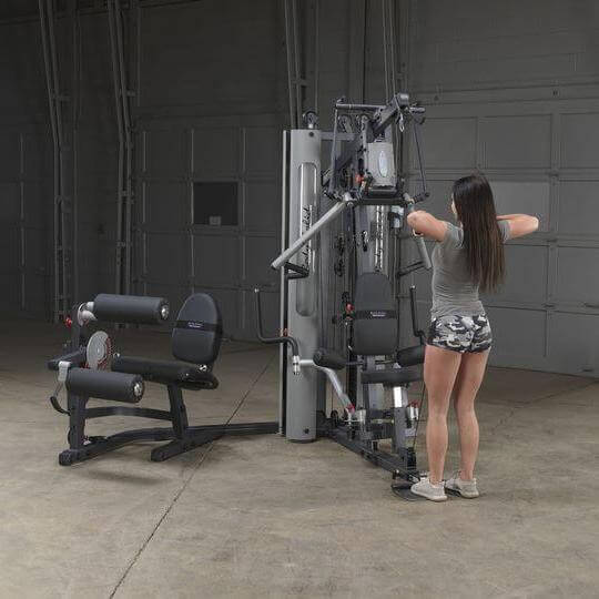 Body-Solid Bi-Angular Multi-Stack Gym G10B - Female model standing doing chest workout