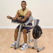 Body-Solid Cam Series Biceps & Triceps GCBT380 - Man in yellow top doing arm workout while smiling at the camera