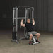 Body-Solid Compact Functional Training Center GDCC210 - Man working out inclined press