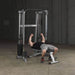 Body-Solid Compact Functional Training Center GDCC210 - Man on bench doing chest press workout