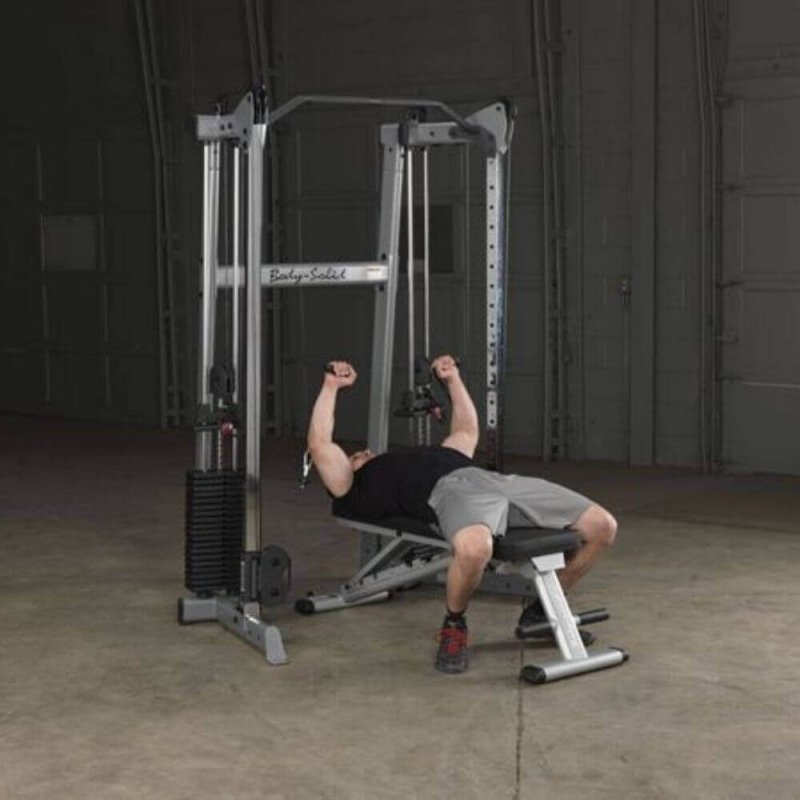 Body-Solid Compact Functional Training Center GDCC210 - Man on bench doing chest press workout