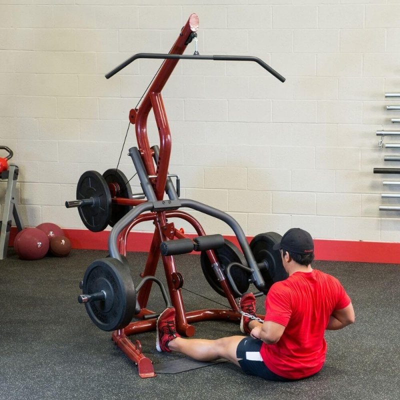 Body-Solid Corner Leverage Gym GLGS100 - Man sitting on the ground and using low pulleys