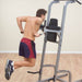 Body-Solid Deluxe Vertical Knee Raise GVKR82 - Man working out in Dips