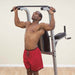 Body-Solid Deluxe Vertical Knee Raise GVKR82 - Man holding the lat bars 