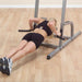 Body-Solid Deluxe Vertical Knee Raise GVKR82 - woman holding both pushup bars