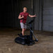 Body-Solid Endurance Center Drive Elliptical E300 - a man on an exercise machine