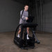 Body-Solid Endurance Center Drive Elliptical E5000 - Man on the equipment and hands on console