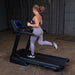 Body-Solid Endurance Folding Treadmill T25 - side view of woman running in the equipment