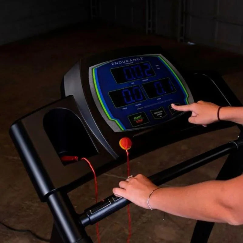 Body-Solid Endurance Walking Treadmill T50 - Screen display with man hand pushing buttons