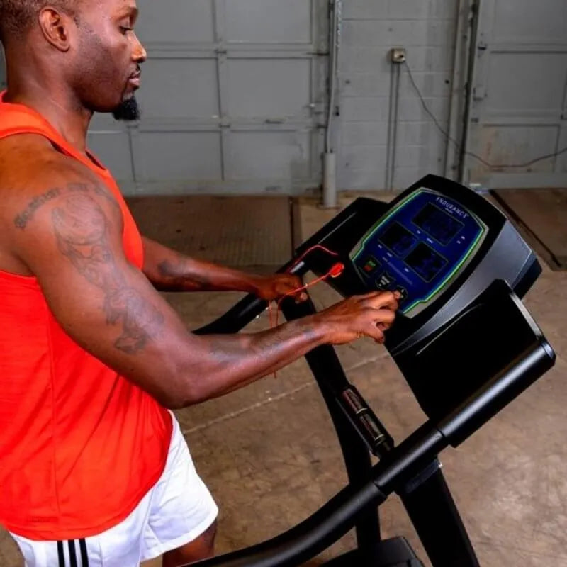 Body-Solid Endurance Walking Treadmill T50 - side view photo of man looking and pushing button son screen  display