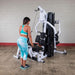 Body-Solid EXM3000LPS Multi-Stack Home Gym - woman on a lat down exercise