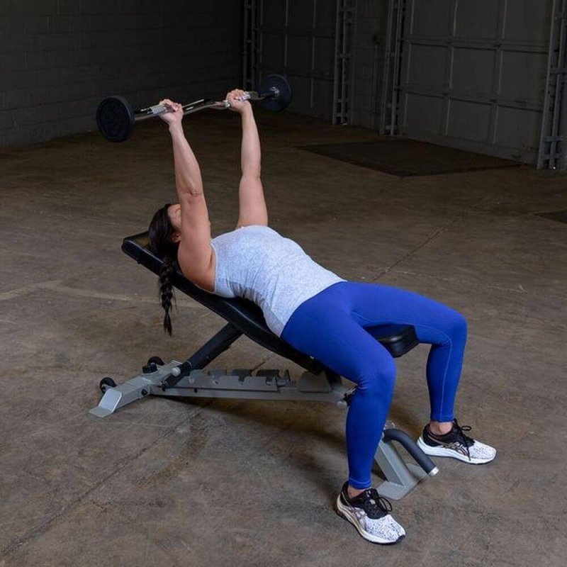 Body-Solid Fixed Curl Bar Sets - Woman fully pulled up the barbell