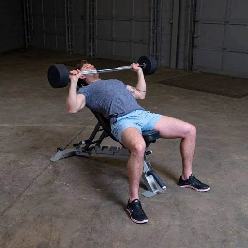 Body-Solid Fixed Straight Bars - Man doing press chess and holding a barbell