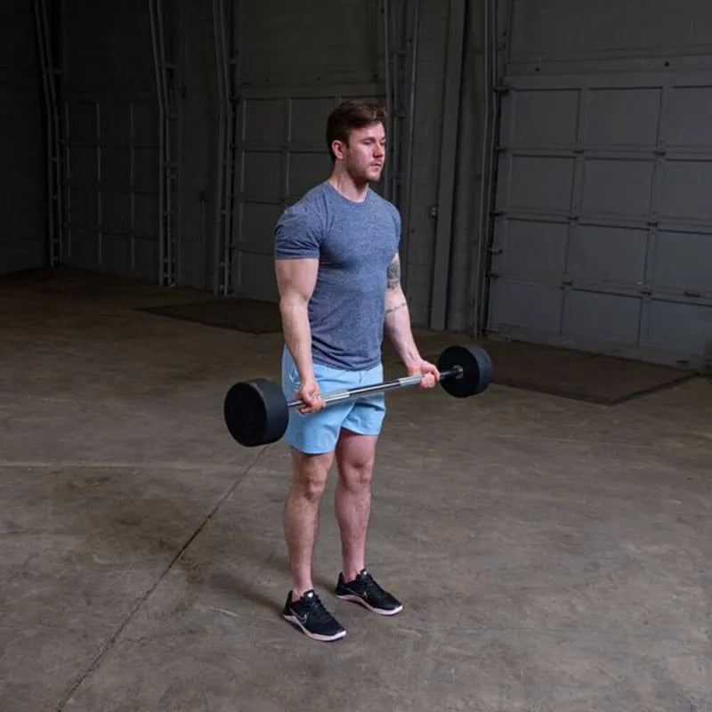Body-Solid Fixed Straight Bars - Man standing while lifting the barbell