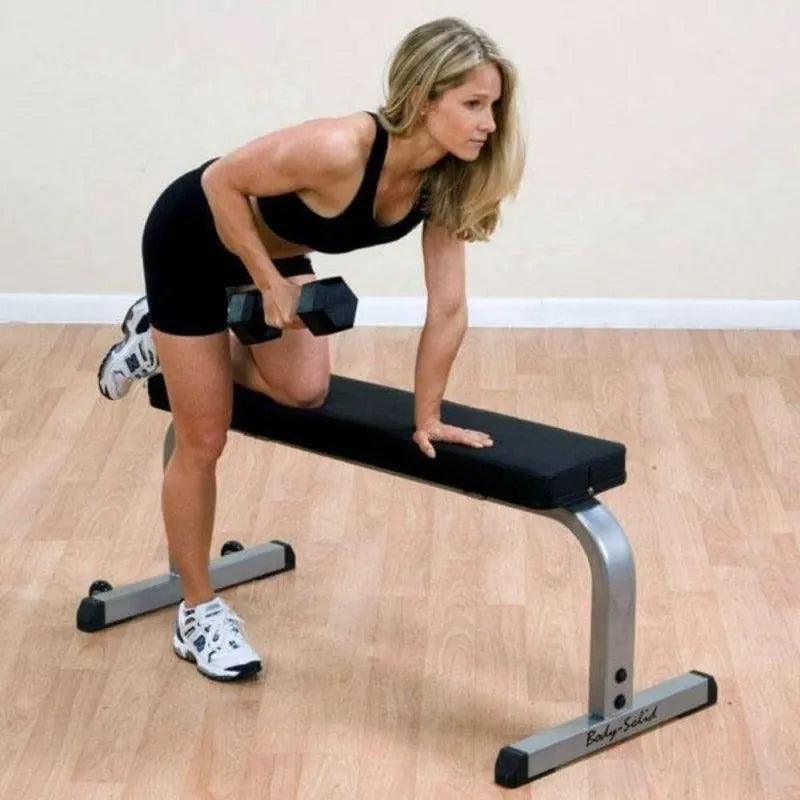 Body-Solid Flat Bench GFB350 - woman working out one leg on the bench and holing a dumbbell