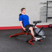 Body-Solid Flat Incline Decline Bench GFID100 - Man on workout with weights above leg lock down