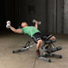 Body-Solid Flat Incline Decline Bench GFID71 - Man laying down on inclined bench holding 2 dumbbells
