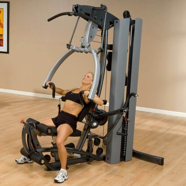 Body-Solid Fusion 600 Personal Trainer F600 - woman on bench pushing up while hands on handle