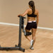 Body-Solid Fusion Multi-Hip Station FMH - woman on training back foot placed in leg support