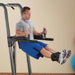 Body-Solid Fusion VKR Dip Pull Up Station FCD - Man sweating doing leg raise exercise