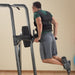 Body-Solid Fusion VKR Dip Pull Up Station FCD - Man pulling up half body using the handles