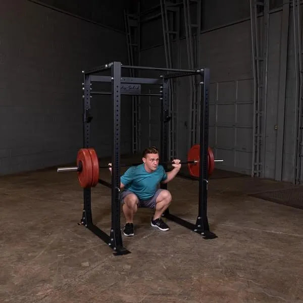 Body-Solid GPR400 Power Rack - Man squat position while holding the barbell on the actual product