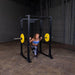 Body-Solid GPR400 Power Rack - Woman knee down while barbell is placed at her back