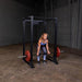 Body-Solid GPR400 Power Rack - Woman working out holding the barbel rod with one plates on opposite sides in color red