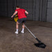 Body-Solid Home Plate T-Bar Row Landmine TBR50 - Man working out with rod placed between his legs holding it with heavy plate