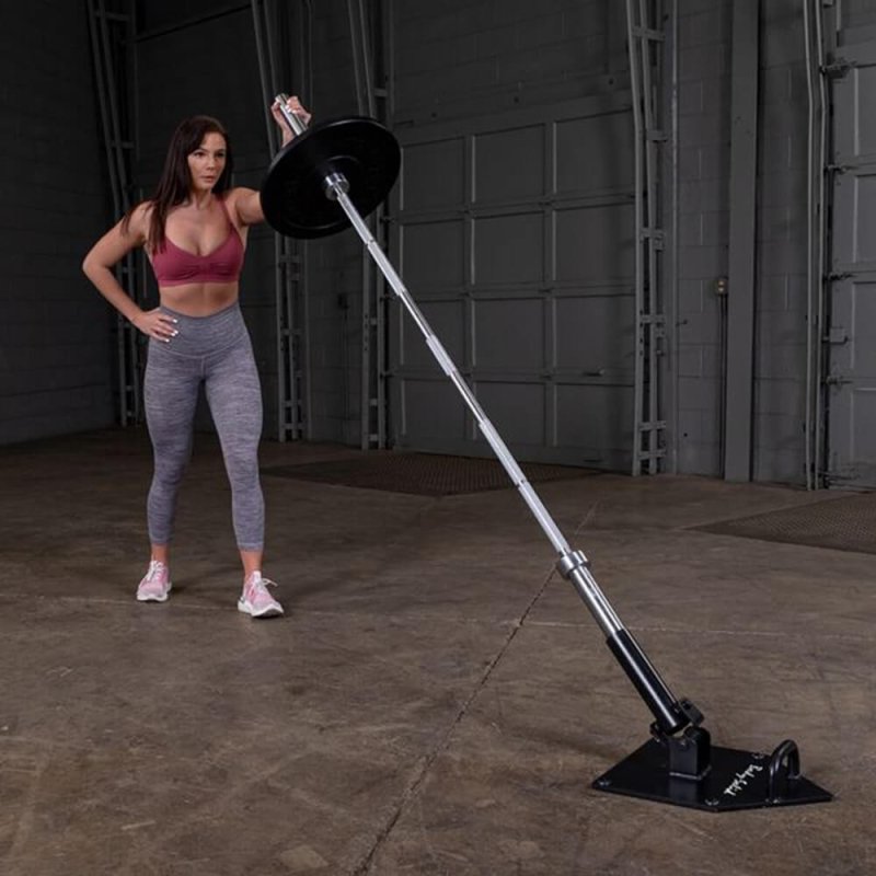 Body-Solid Home Plate T-Bar Row Landmine TBR50 - woman holding the rod in one hand with one plate in black on it