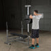 Body-Solid Lat Pull Low Row Attachment GLRA81 - man doing workout with his arms lifting lat bars on both hands 