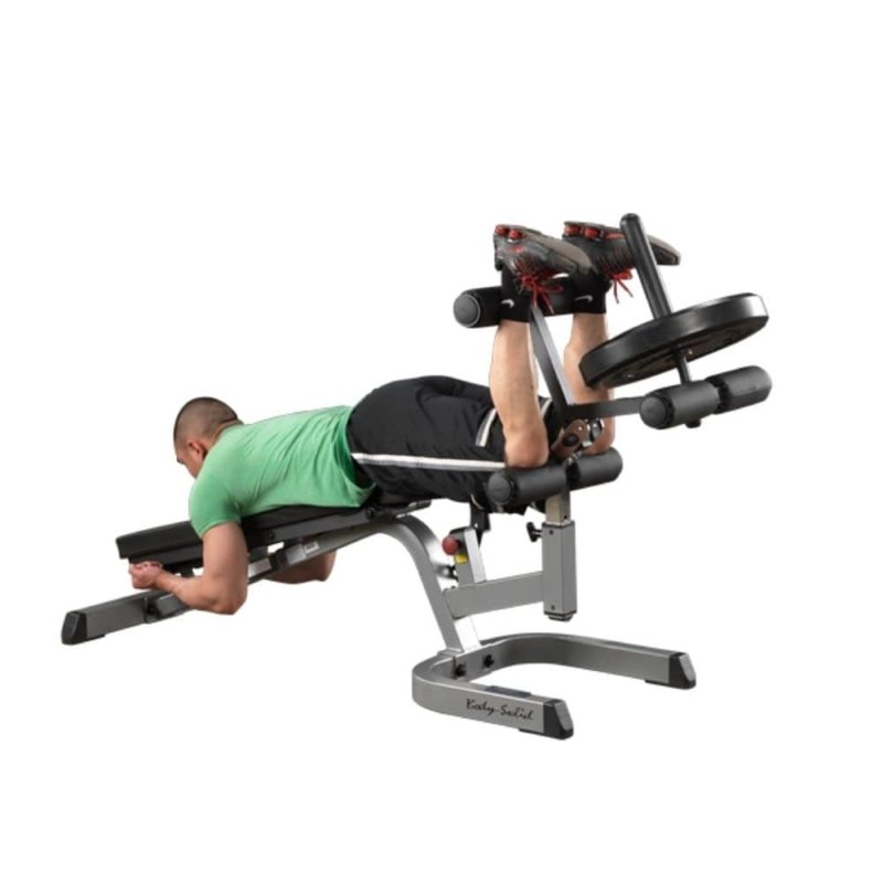 Body-Solid Leg Developer Attachment GLDA3 man in inclined position, using leg support with weight plate