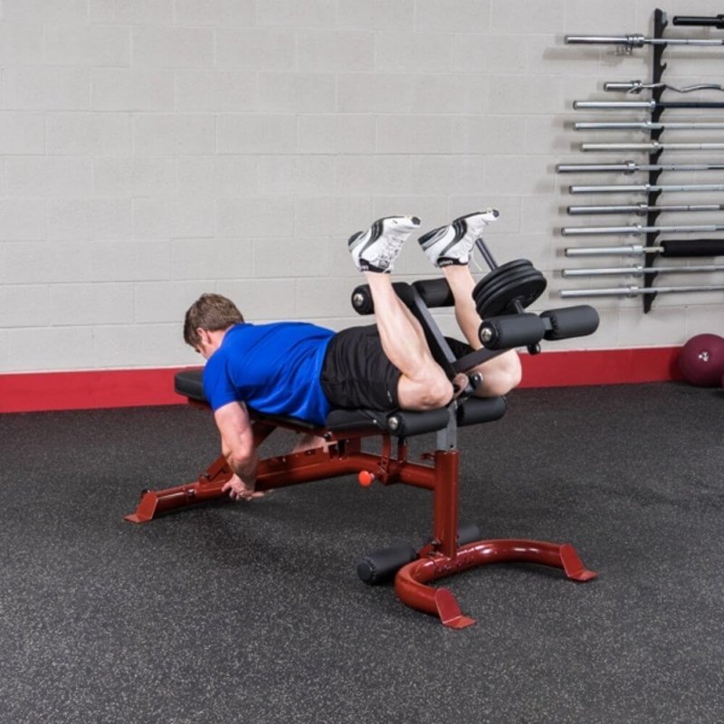 Body-Solid Leg Developer Attachment GLDA3 - Man laying down and using cushioned leg support with weights 