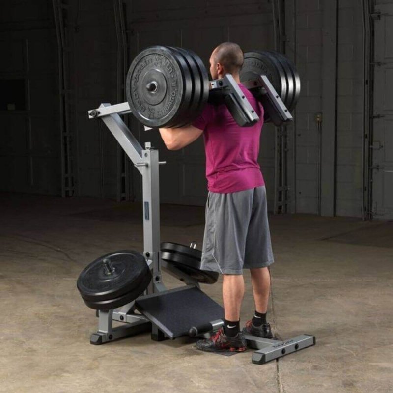 Body-Solid Leverage Squat Calf Machine GSCL360 - a man lifting weights in a gym