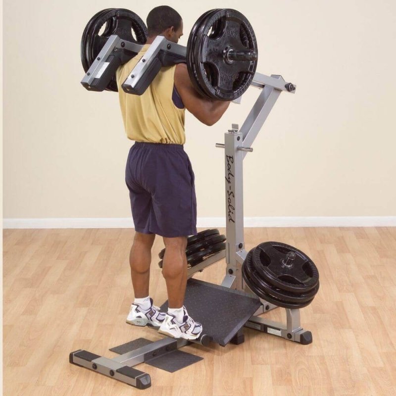 Body-Solid Leverage Squat Calf Machine GSCL360 - Man on a foot support tiptoed 