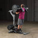 Body-Solid Leverage Squat Calf Machine GSCL360 - back view of a man lifting weights on a machine