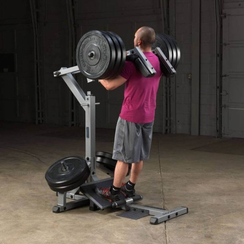 Body-Solid Leverage Squat Calf Machine GSCL360 - back view of a man lifting weights on a machine