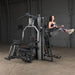 Body-Solid Multi-Stack Home Gym System G9S - woman lifting herself using her arms