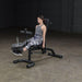 Body-Solid Olympic Leverage Exercise Bench with Leg Developer FID46 - Side view photo of woman on leg extension workout