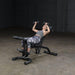 Body-Solid Olympic Leverage Exercise Bench with Leg Developer FID46 - woman laying down with should press exercise