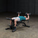 Body-Solid Olympic Leverage Exercise Bench with Leg Developer FID46 - Man laying down doing dumbbell bench press