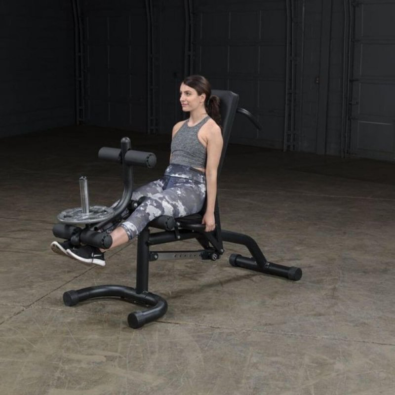 Body-Solid Olympic Leverage Exercise Bench with Leg Developer FID46 - woman working out sitting straight doing leg extension exercise 