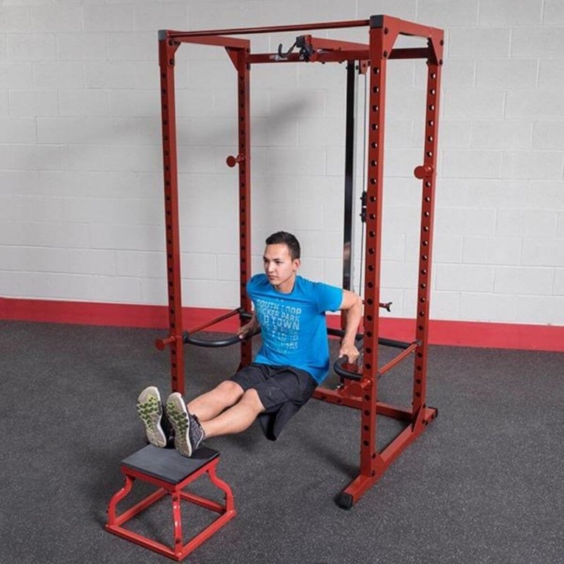 Body-Solid Power Rack Dip Attachment DR100 - man working out with legs on the gym chair and hand on handles