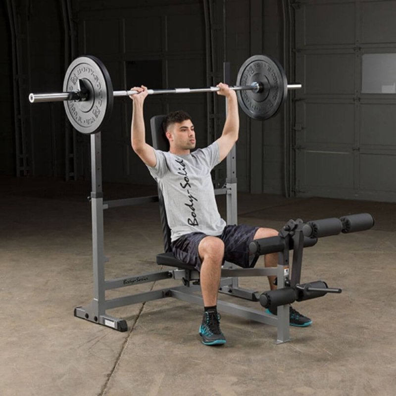 Body-Solid PowerCenter Rack Bench Combo GDIB46L - Man sitting on seat cushioned and pull up a barbell 