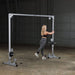 Body-Solid Powerline Cable Crossover PCCO90X - woman exercising next to the metal bar