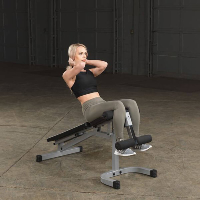 Body-Solid Powerline Flat Incline Decline Bench PFID130X - woman doing situps on the bench